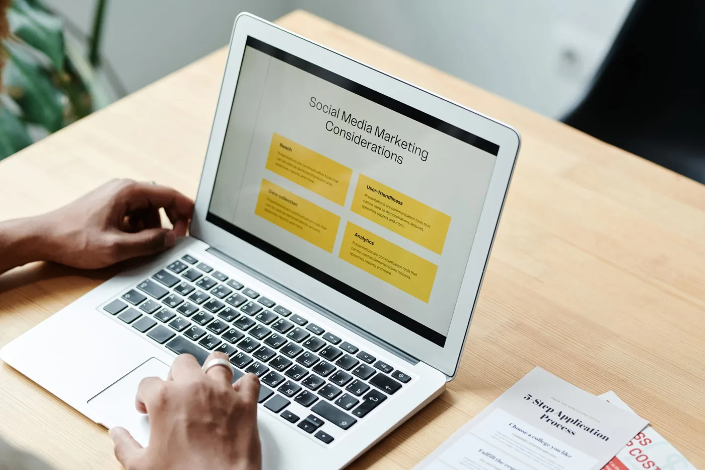 A marketer reviewing social media analytics and tracked link click data on a laptop dashboard