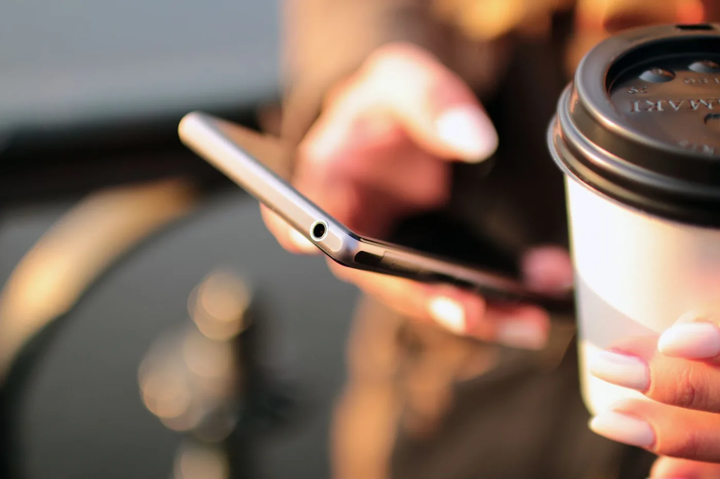 A smartphone screen showing an SMS message with a short branded marketing link and a high open rate notification