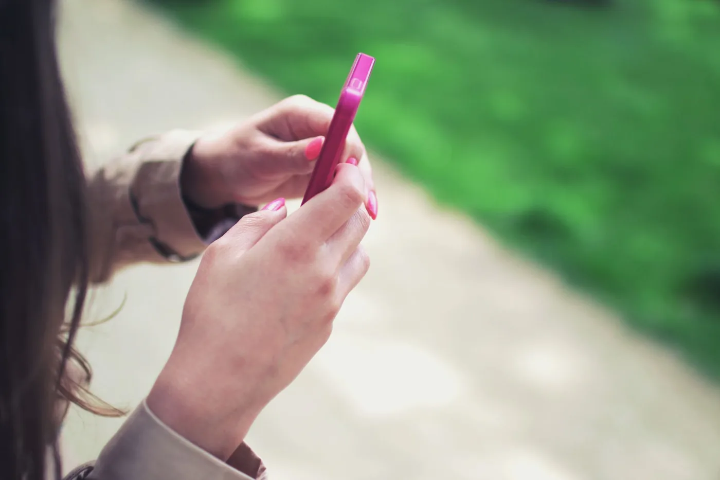 A smartphone displaying TikTok with a short trackable link ready to share in the bio section