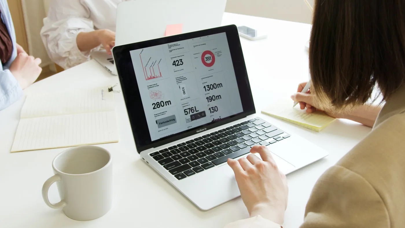 A small business owner reviewing link analytics on a laptop at a desk